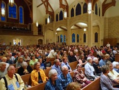 crowd nearly fills the sanctuary