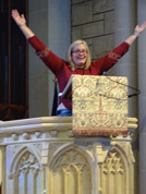 Melanie greets volunteers from the pulpit