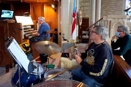 Marvin Faulwell practices on cathedral organ and Bob Keckeisen provides percussion accompaniment