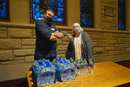 Brian Sanders and Zrandra Myrick helped sell bottled water to support Grace Catheral