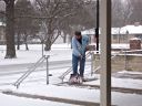 Bill shovels snow on front step