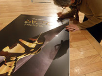 Annette signs Oscar poster