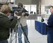 Topeka media hone in for a close-up of Denise and the statuette.