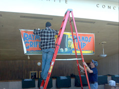Trevor climbs the ladder to dismount the Hands Up banner