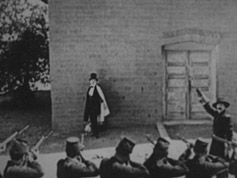 Raymond Griffth faces a firing squad in the comedy Hands Up