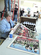 Enid rolls up posters for sale