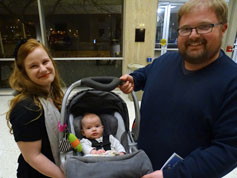 One of two 4-month-old attendees, here with parents