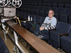 Bruce Calvert helps run film projectors
