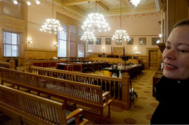 Karie stands in the room once used by the Kansas Supreme Court
