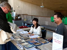Volunteers help attendees purchase DVDs