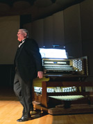Marvin Faulwell takes a bow at the pipe organ after accompanying Why Worry?