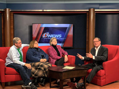 Bill Shaffer, Denise Morrison, and Tracey Goessel converse at WIBW with Ralph Hipp