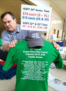 Staff member Brian Sanders sets up t-shirt sales display