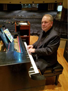 Jeff Rapsis, in Kansas from New Hampshire, warms up onstage at the grand piano