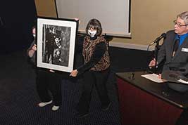 Staffers Jane Bartholomew and Carol Yoho display a door prize image with Charlie Chaplin and Jackie Coogan in the feature film The Kid.