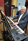 Bill Beningfield tries out a rented electronic keyboard.