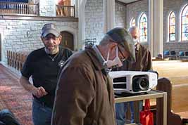 Karl Mischler, Bill Shaffer and J.B. Kaufman set up and check running of featured films on the DVD projector.