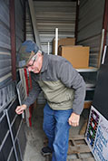 Bill Shaffer helps move itams back into storage