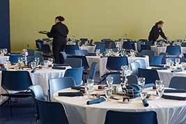 Dinner caterers work at setting tables