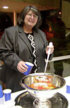 Barbara Lerma, a volunteer from Overbrook, Kansas, serves up some punch