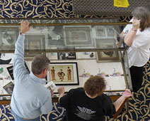 Bill, Jane and Phyllis fill a display case