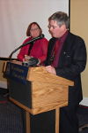 Denise listens as Bill introduces special banquet guests