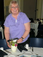 Zandra fixes a table centerpiece for our banquet