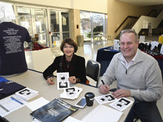 Dr. Harriet Fields and Gary Pratt sign copies of Gary's W.C. Fields drawing to be given to dinner guests