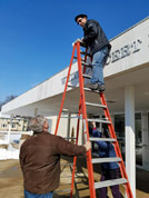 Karl Mischler climbs a taller ladder