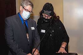 Bill Shaffer makes door prize plans with staffer Melanie Lawrence.