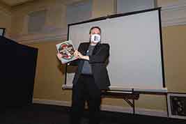 Staffer Biran Sanders displays a door prize.