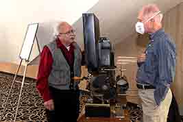 Ken Filardo talks with an attendee about details concerning the projector he put onto display