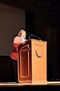 Denise Morrison stands at the podium to welcome guests and introduce films to be shown