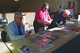 KSFF Board Members help at the front table in White Concert Hall Lobby