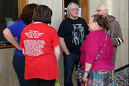 Attendees chats, all wearing t-shirts or sweatshirts