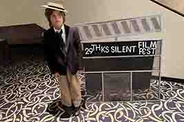 Fleet Kinsey from Lawrence, KS, poses in the lobby with our 2026 Event Clip-Board