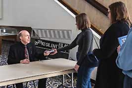 Ben Model hands off a book he just signed