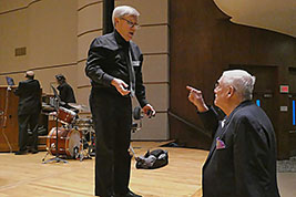 Musicans gather to pick up their music after the event ends