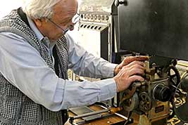 Ken Filardo sets up his Motion Picture Projector in the the lobby of White Concert Hall