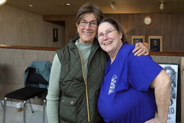 Our 2026 Guest Speaker, Melissa Talmadge Cox hugs Jane Bartholomew in White Concert Hall Lobby